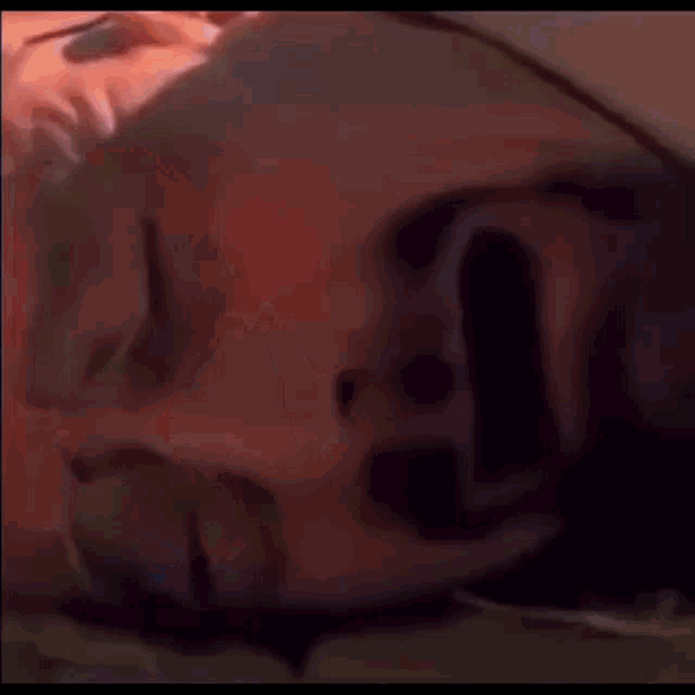 a person is laying on the ground with their head on the ground .