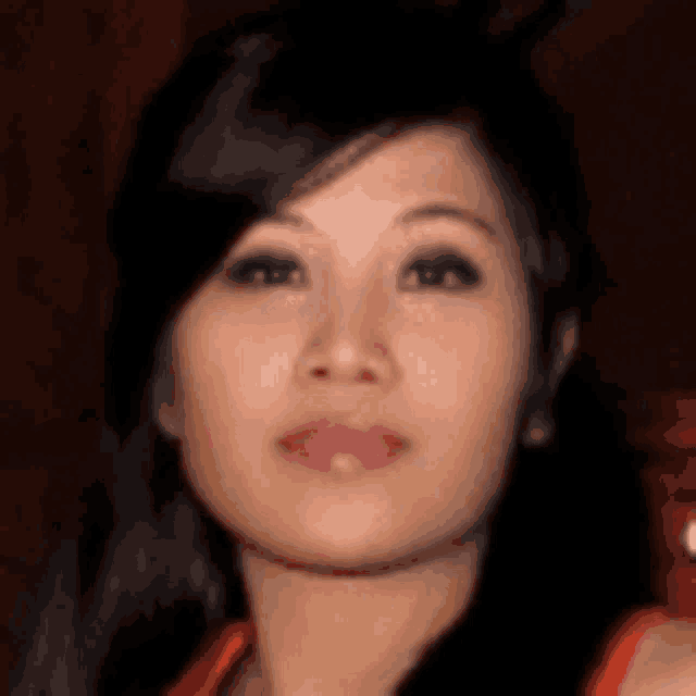 a close up of a woman 's face with a blurred background