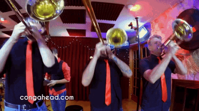 a group of men playing brass instruments with the website congahead.com in the background