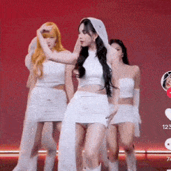 a woman in a white dress with a hood on her head is dancing