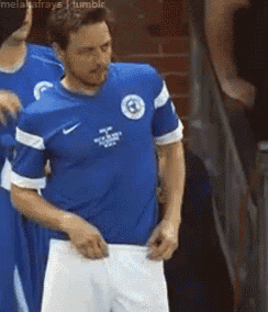 a man in a blue shirt with the number 6 on the front
