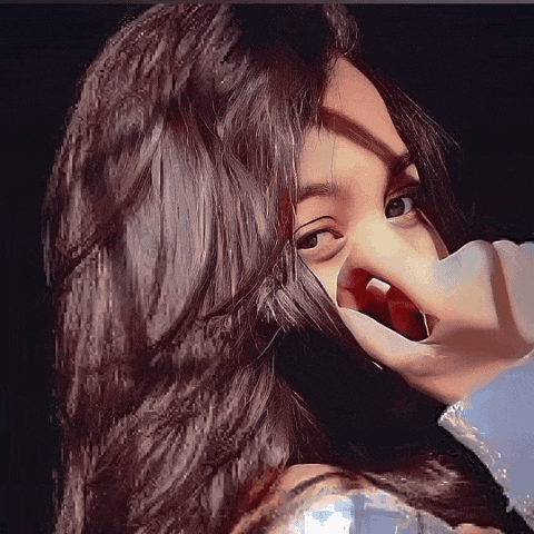 a close up of a woman covering her face with her hands