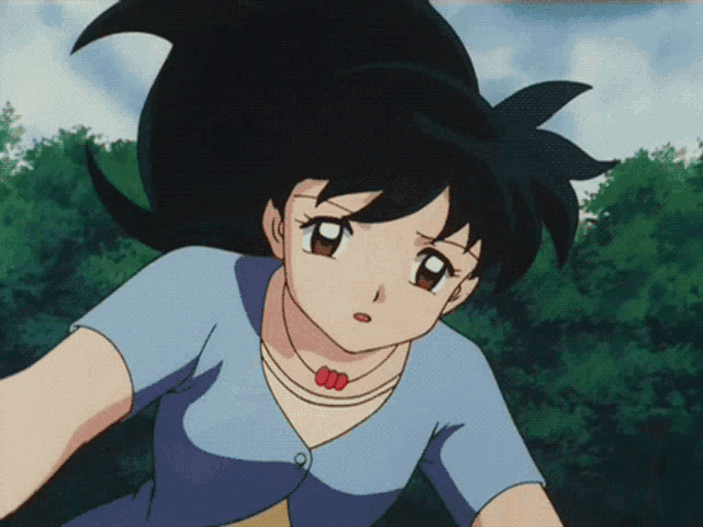 a girl with black hair is wearing a blue shirt and a yellow shirt