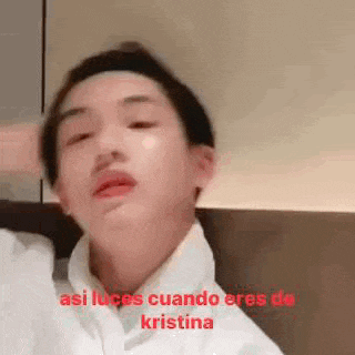 a close up of a person 's face with the words `` asi luces cuando eres de kristina '' written in red .