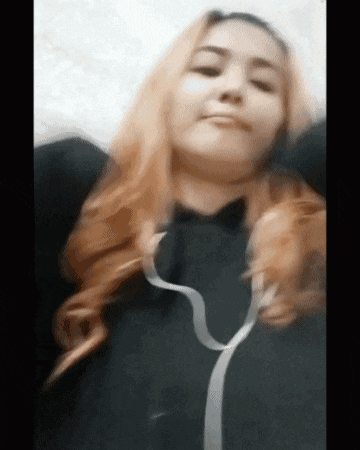 a woman with long red hair is wearing headphones and a black shirt