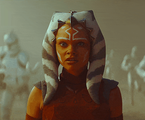 a woman in a star wars costume has a striped headband on