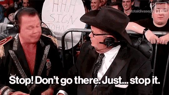 two men are sitting in front of a crowd with a sign that says stop ! don 't go there . just stop it .