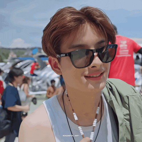 a close up of a person wearing sunglasses with khunpol gif on the bottom right