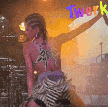 a woman is dancing on stage with the word twerk in the background