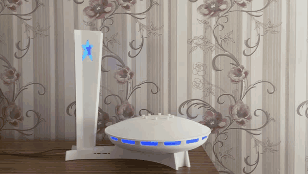 a white device with a blue star on the top sits on a table
