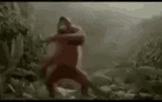 a spongebob squarepants character is standing in the middle of a forest .