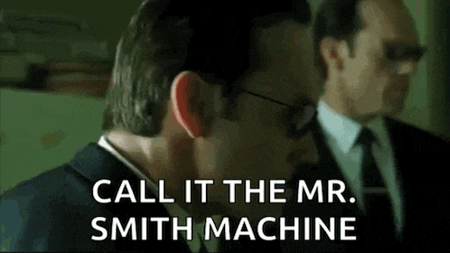 a man in a suit and tie is talking to another man in a suit .
