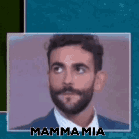 a man with a beard is wearing a suit and tie and looking up .