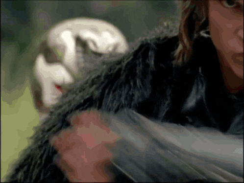 a person in a fur coat is holding a feather
