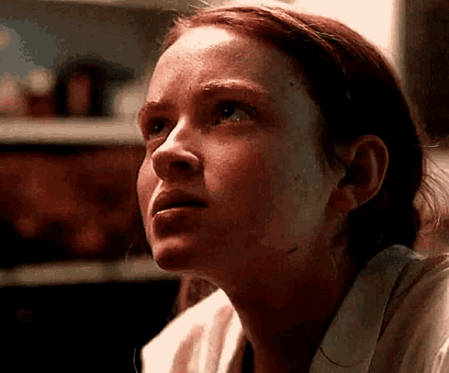a close up of a woman 's face with a tear running down her face .