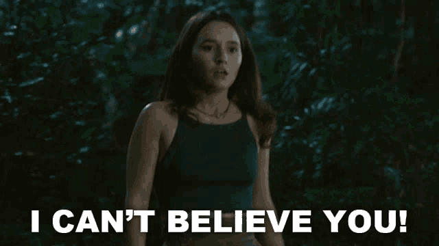 a woman says i can 't believe you while standing in the woods