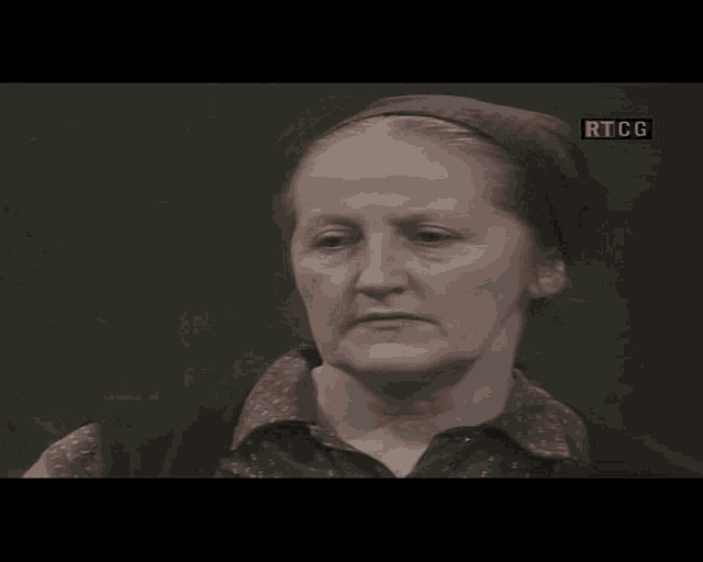 a woman with a head scarf on her head is on a screen that says rtcg