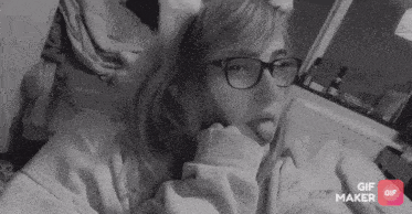a black and white photo of a woman wearing glasses and a gif maker button