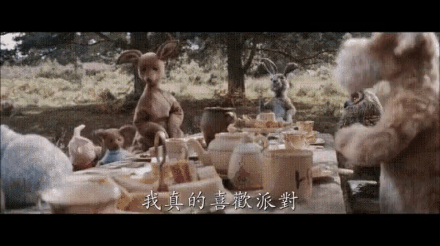 a group of stuffed animals sitting around a table with chinese writing on the bottom