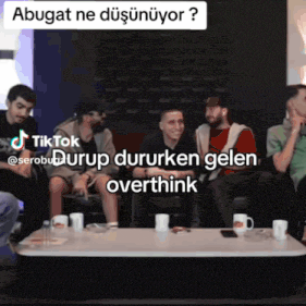 a group of men are sitting around a table with a tik tok watermark