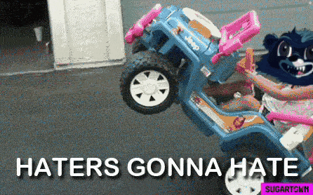 a girl is riding a toy jeep with the words haters gonna hate on the bottom