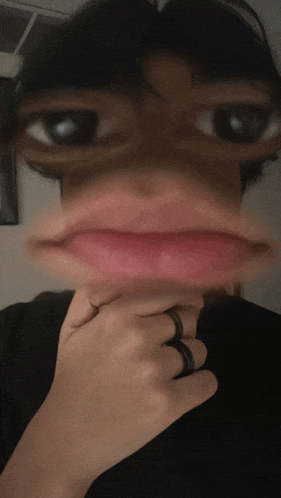 a blurry picture of a person 's face with a black shirt