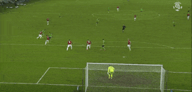 a group of soccer players on a field with the letter r on the bottom right corner