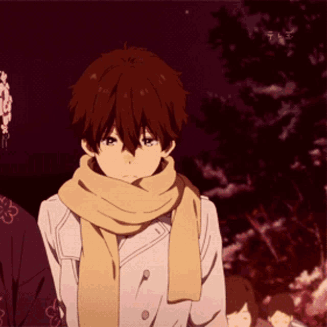 a boy wearing a scarf and a white coat