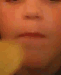 a close up of a person 's face with a slight smile on their face .
