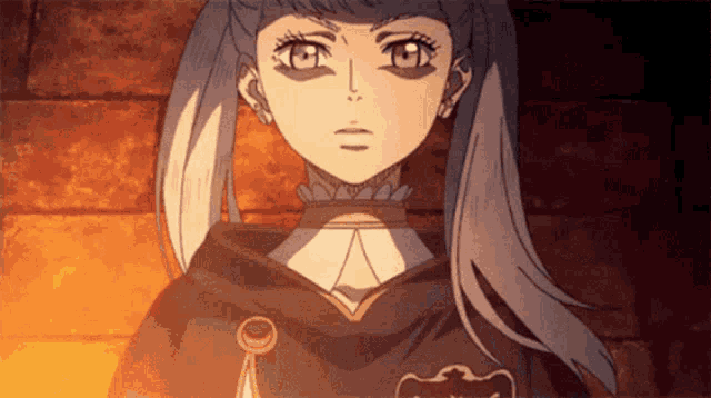 a close up of a girl 's face with a black cape on