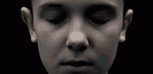 a close up of a child 's face with their eyes closed .