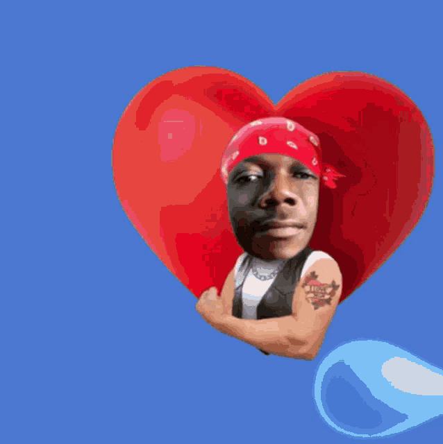 a man with a tattoo on his arm is holding a heart