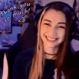 a woman wearing headphones is smiling and looking at the camera .