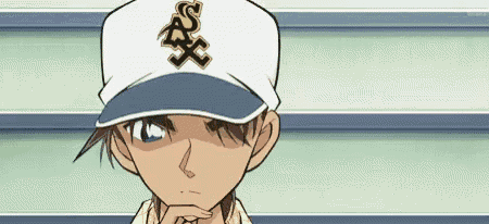 a boy wearing a baseball cap with the letter s on it .
