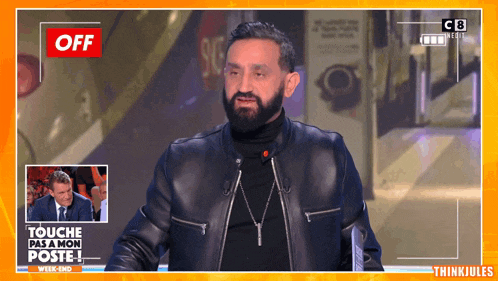 a man with a beard is on a tv show called " touche pas a mon poste "