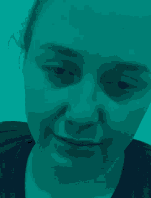 a close up of a woman 's face in a red background .