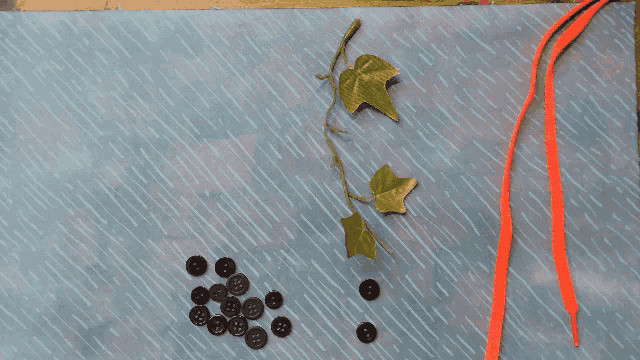a bunch of buttons and a plant are on a blue surface