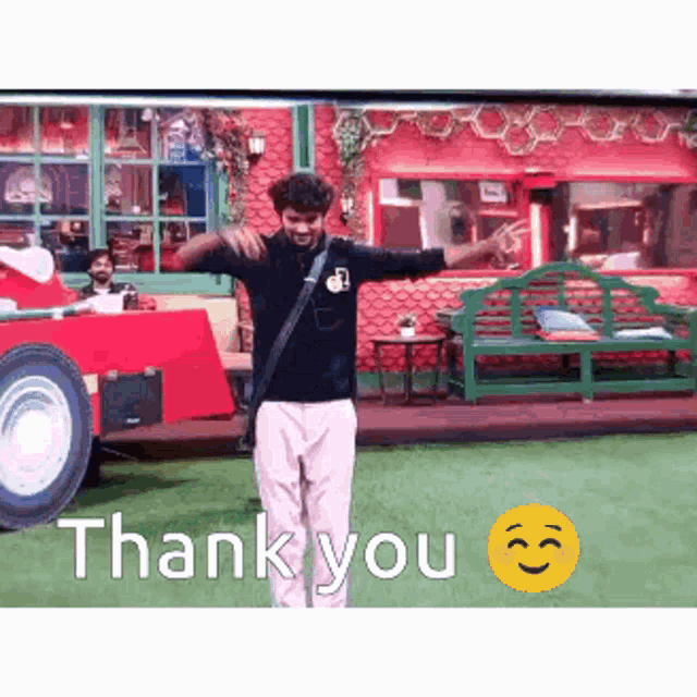 a man is standing in front of a red car with his arms outstretched and a thank you smiley face .