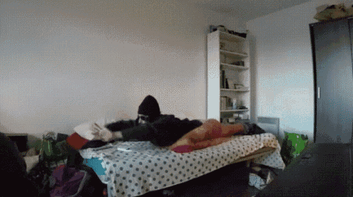 a person laying on a bed in a room