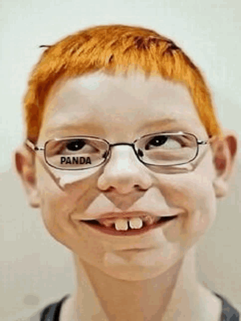 a young boy wearing glasses with the word panda on his eye