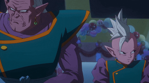 a man and a boy are standing next to each other in a dark room