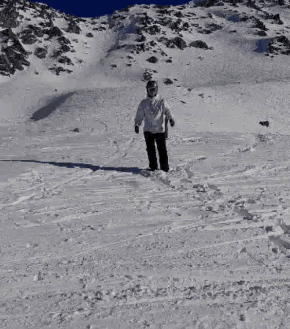 a person standing on a snow covered mountain