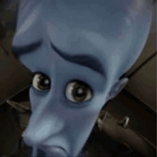 a close up of a cartoon character 's face with green eyes and a sad look on his face .