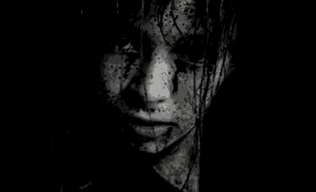 it is a black and white photo of a woman 's face with blood on it .