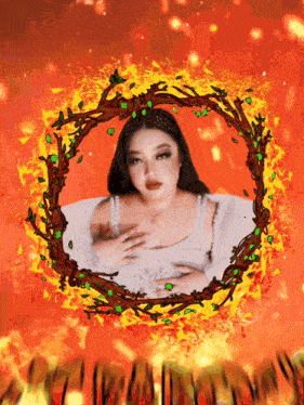 a woman in a white dress is surrounded by flames