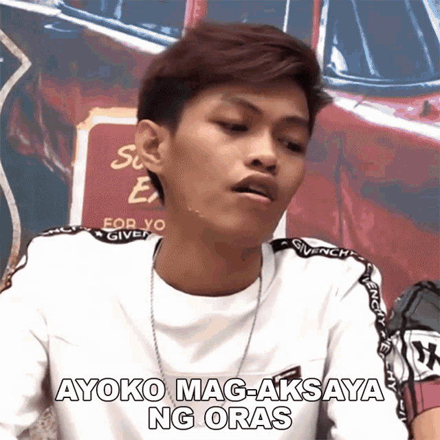 a young man wearing a white shirt that says ayoko mag-aksaya ng oras on it