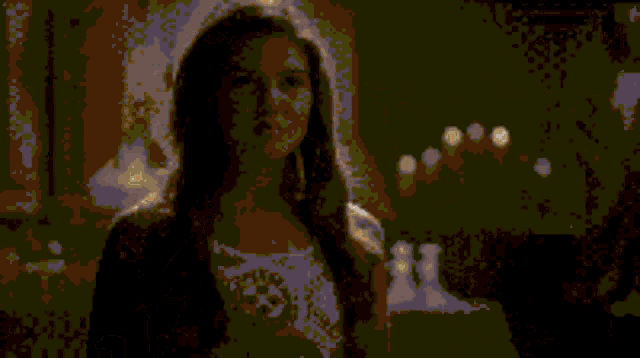 a pixelated image of a woman 's face with a green background