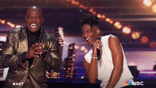two men on a stage with the nbc logo on the bottom right