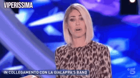 a woman in a leopard print top is talking on a tv show called viperissima