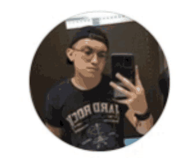 a young man is taking a selfie with his phone in a circle .